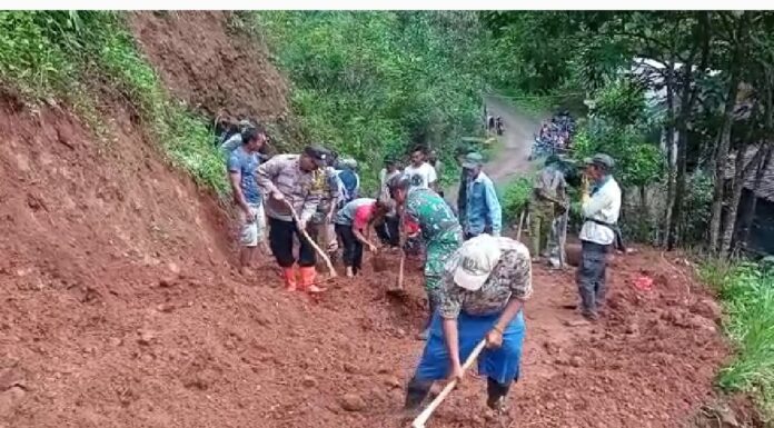 Sertu Udi Supriadi Bantu Warga Bersihkan Tanah Longsor di Desa Cikidang karena intensitas hujan yang terus menerus